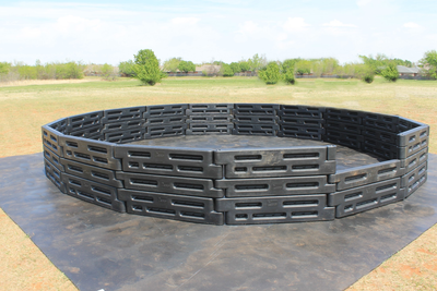 20 foot high-wall gaga ball pit set up on a field, three rows of plastic border timbers