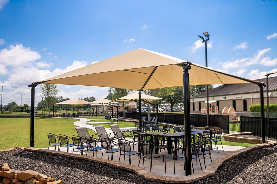 Superior Shade square hip end fabric shade over outdoor café seating