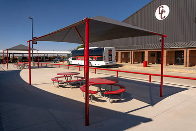 Superior Shade rectangle hip end fabric shade over a school playground