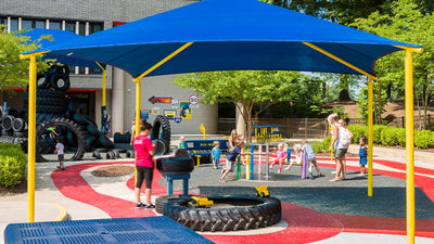 Superior Shade square hip end fabric shade over a children's playground